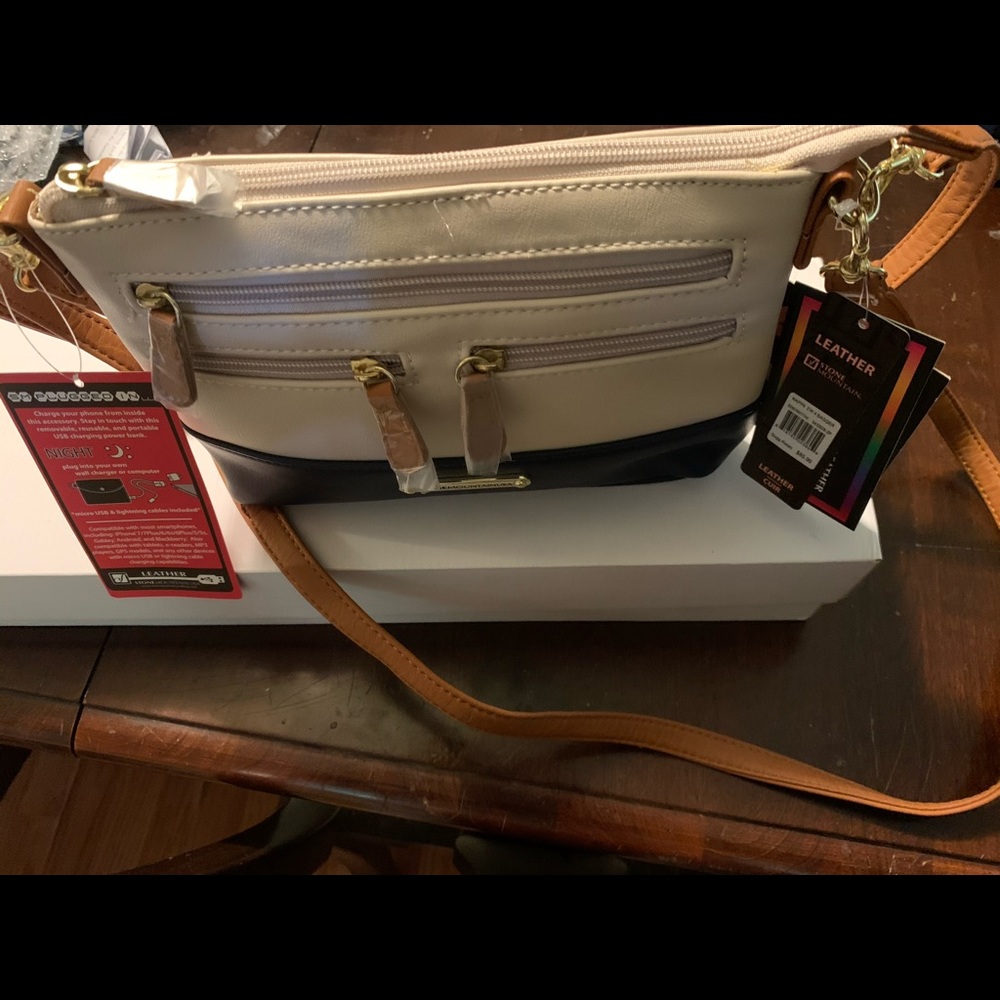 Leather bag w/charger built in.4 in 1 bag. NWT